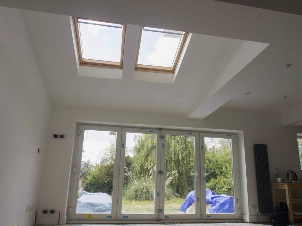 Bright new room with two roof windows and glazed folding doors onto the garden