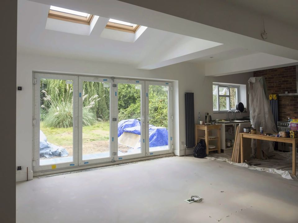 Room part-way through fitting out, with roof windows and folding doors