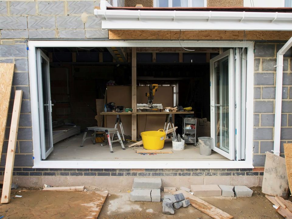 Glazed folding doors fitted in new blockwork, tools inside
