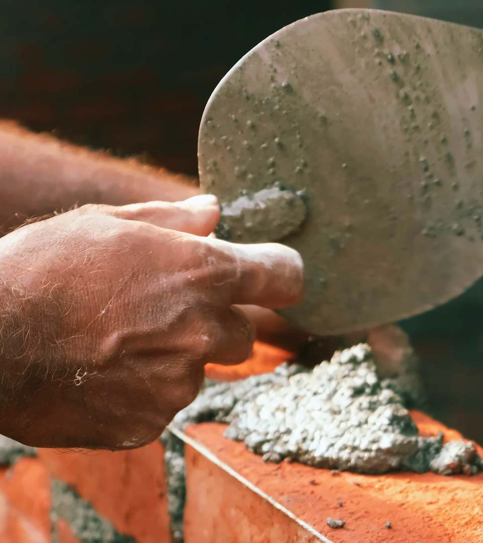 Trowel and mortar on a fresh course of brickwork