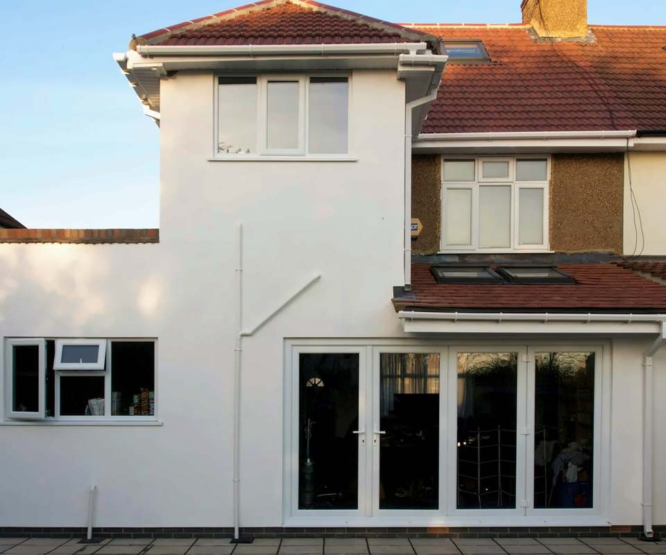 Finished double storey rear extension on a semi-detached house, glazed doors onto the patio