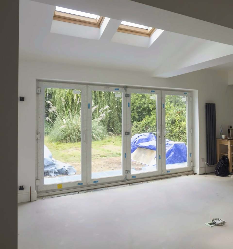 Room part-way through fitting out, with roof windows and folding doors